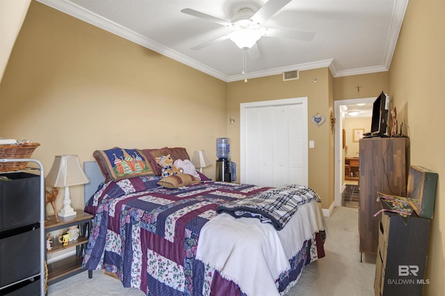 bedroom with visible vents, crown molding, a closet, a ceiling fan, and carpet
