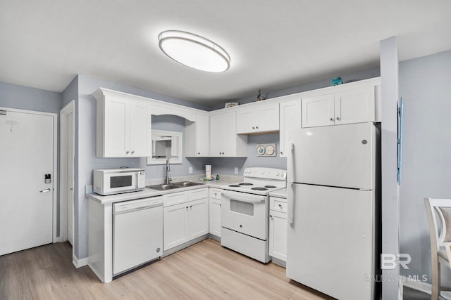 kitchen featuring white cabinets, white appliances, a textured ceiling, light hardwood / wood-style flooring, and sink