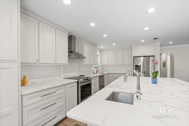 kitchen featuring white cabinets, sink, wall chimney range hood, stainless steel appliances, and light stone countertops