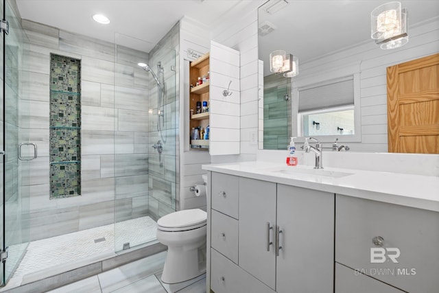 bathroom with vanity, toilet, and an enclosed shower