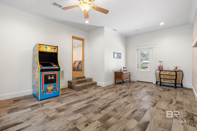 interior space featuring ceiling fan, ornamental molding, and light hardwood / wood-style floors