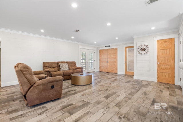 living room with french doors, light hardwood / wood-style floors, and ornamental molding