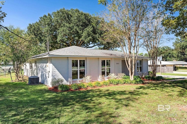 single story home featuring a front yard and cooling unit