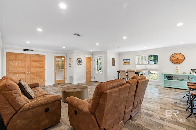 living room featuring light hardwood / wood-style floors and ornamental molding