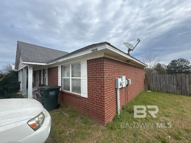 view of side of home featuring a lawn