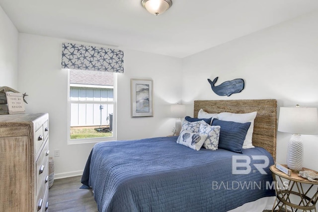 bedroom with dark hardwood / wood-style flooring