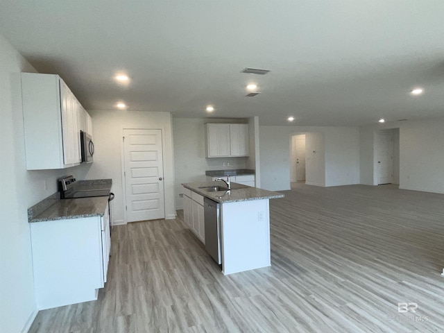 kitchen with sink, white cabinetry, a center island with sink, stainless steel appliances, and light hardwood / wood-style floors