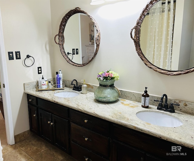 bathroom featuring double vanity, a sink, and tile patterned floors