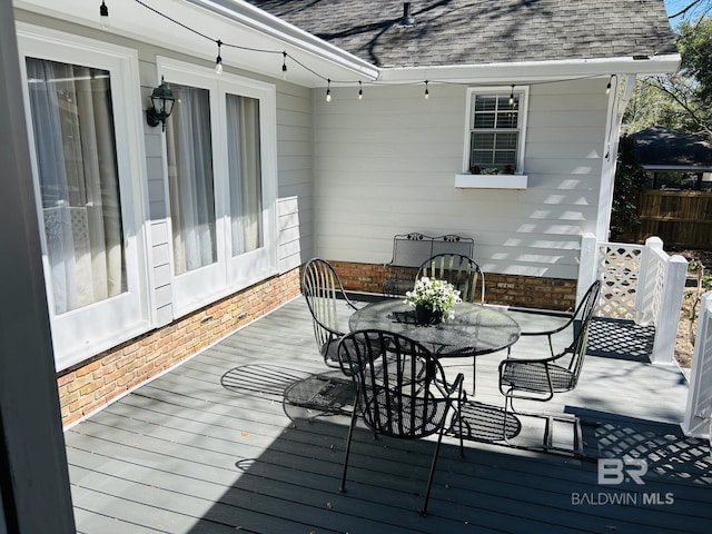 wooden terrace featuring outdoor dining space