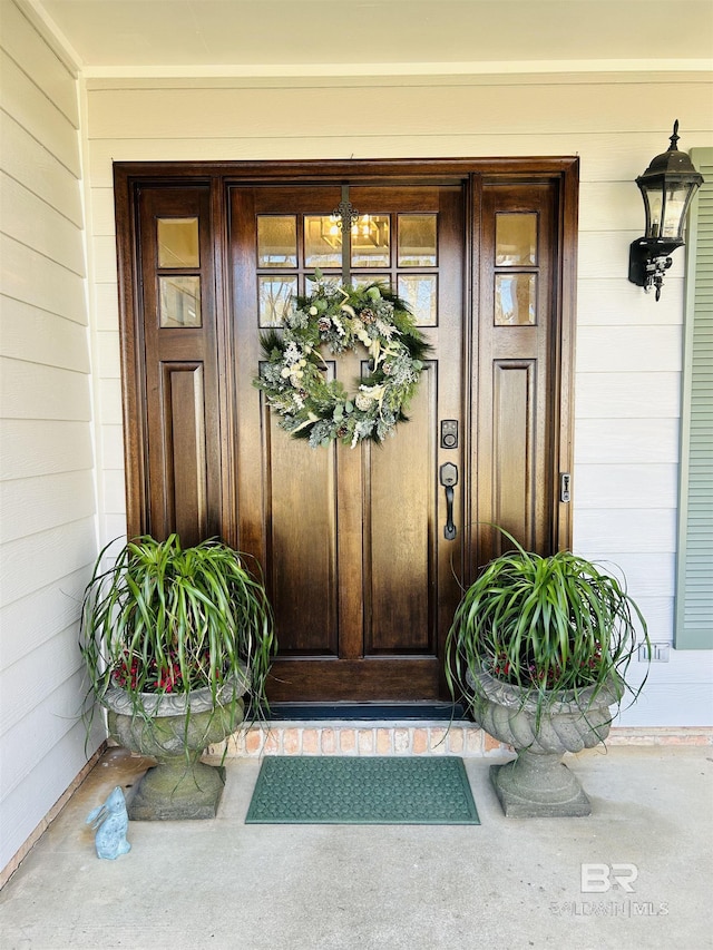 view of exterior entry with a porch