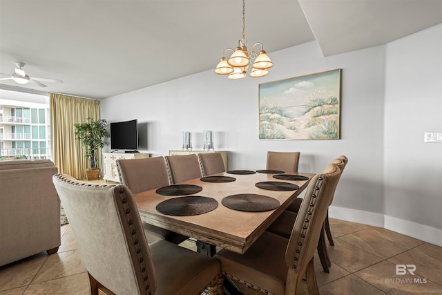 dining area with ceiling fan with notable chandelier and light tile patterned floors