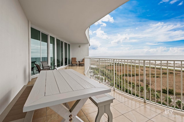 balcony featuring a water view and a view of the beach