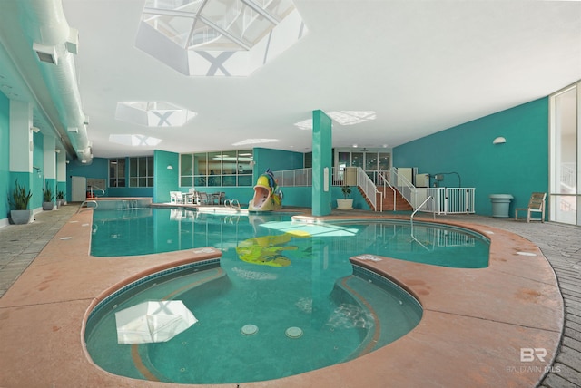 view of pool featuring a skylight