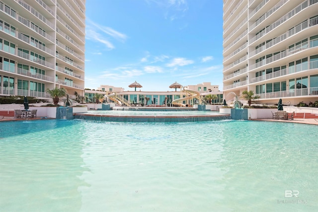 view of pool featuring pool water feature and a water slide