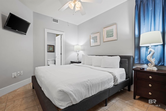 tiled bedroom featuring ceiling fan