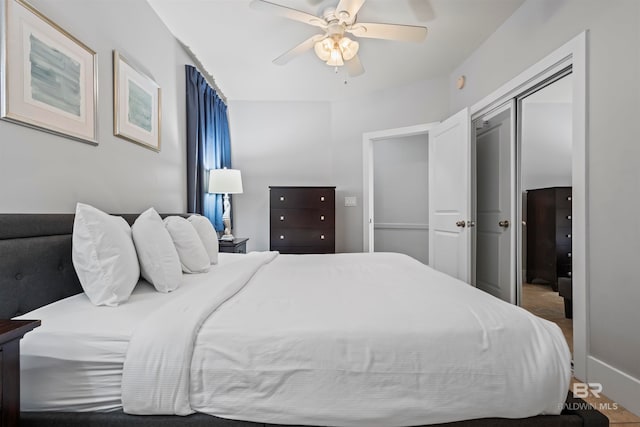 bedroom with ceiling fan and a closet