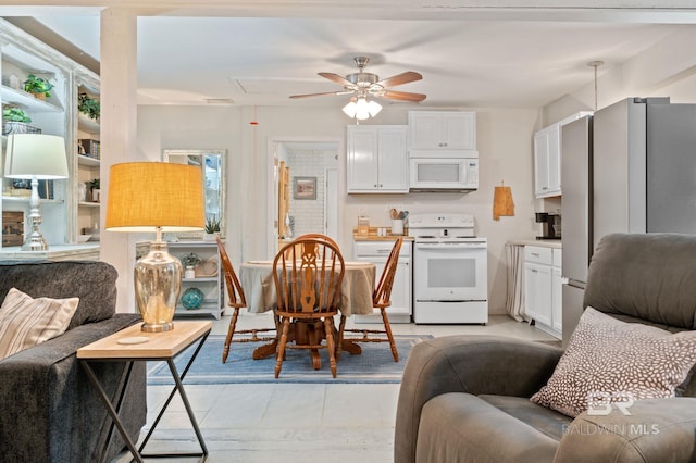 living area featuring ceiling fan and light tile patterned flooring