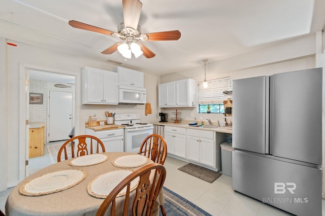 kitchen with ceiling fan, white cabinetry, hanging light fixtures, light tile patterned floors, and white appliances