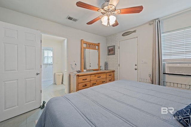 bedroom featuring ceiling fan, ensuite bath, light tile patterned floors, and cooling unit