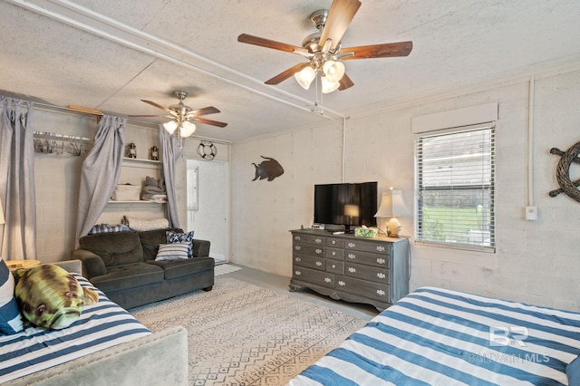 bedroom with a textured ceiling and ceiling fan