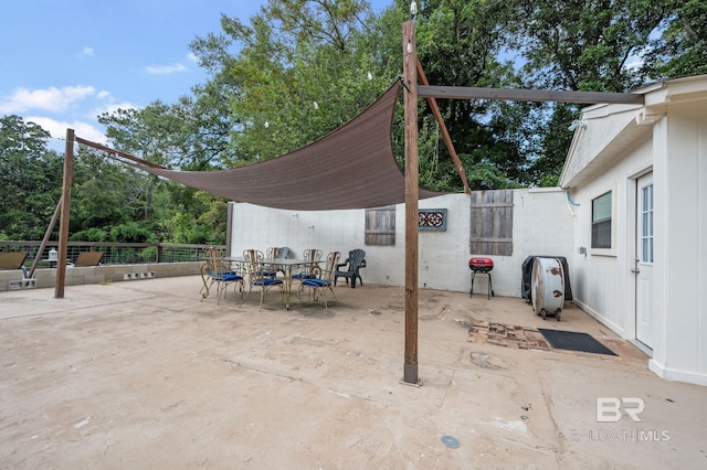 view of patio / terrace featuring outdoor dining area and fence