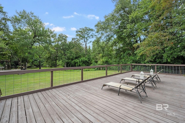 wooden terrace featuring a yard