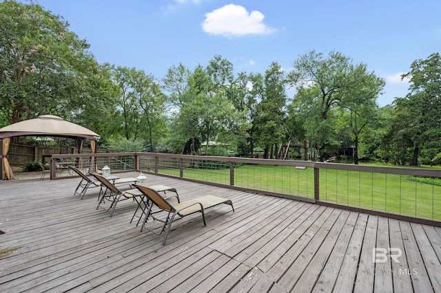 wooden terrace with a lawn and a gazebo