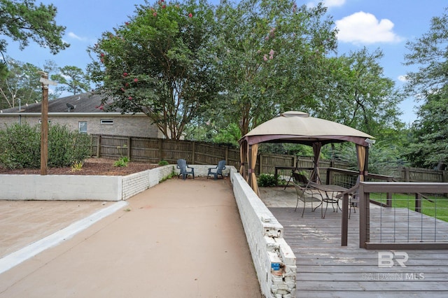 wooden deck with a gazebo and fence