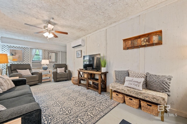 living room featuring a textured ceiling, a wall mounted AC, and ceiling fan