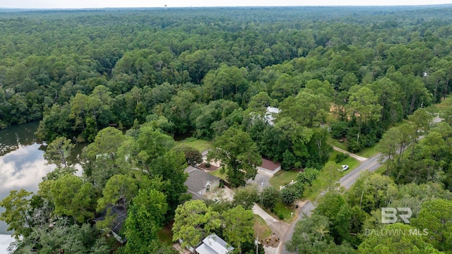 birds eye view of property featuring a wooded view