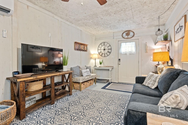 tiled living room with a wall unit AC, a textured ceiling, and ceiling fan