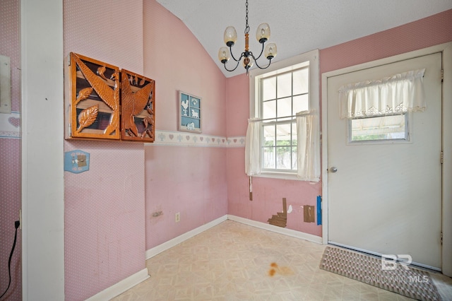 interior space featuring vaulted ceiling and a notable chandelier