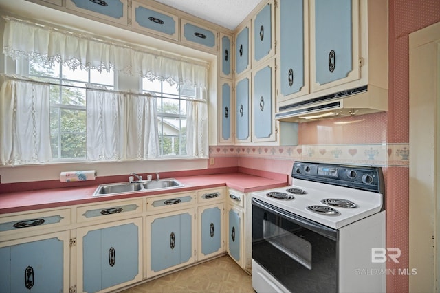 kitchen featuring sink, electric stove, and a textured ceiling