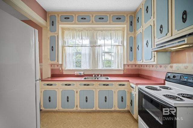 kitchen with white appliances, sink, and a textured ceiling