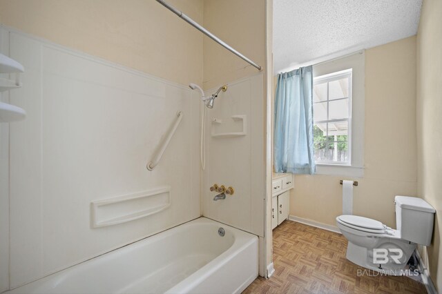 full bathroom featuring vanity, bathing tub / shower combination, parquet flooring, toilet, and a textured ceiling