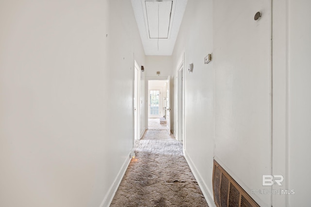 hall featuring light colored carpet