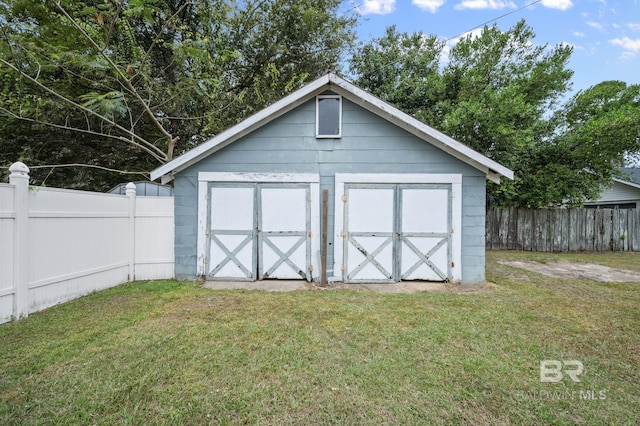 view of outdoor structure featuring a lawn