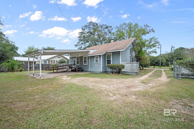 back of house with a lawn