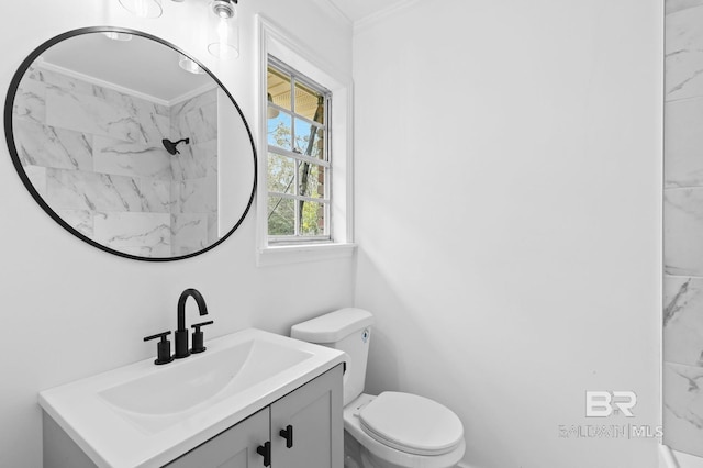 bathroom featuring toilet, vanity, and crown molding