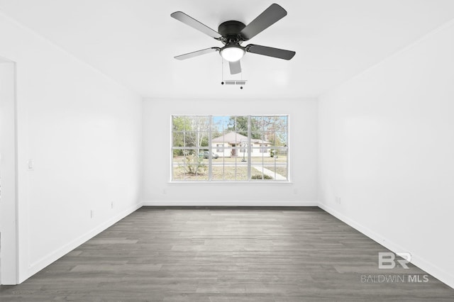 unfurnished room featuring ceiling fan and dark hardwood / wood-style floors