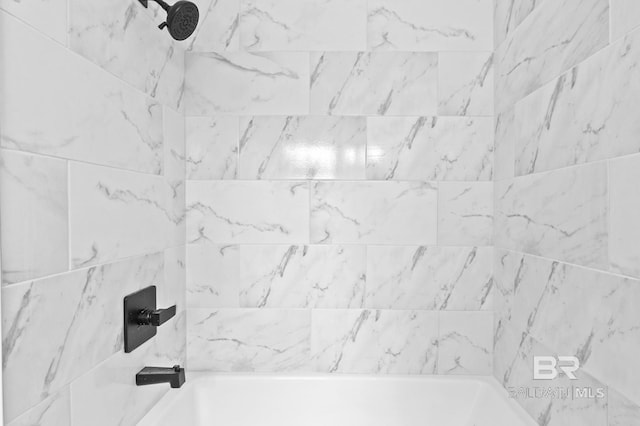 interior details featuring tiled shower / bath