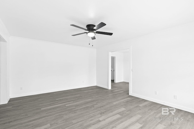 unfurnished room with ceiling fan, crown molding, and dark hardwood / wood-style flooring