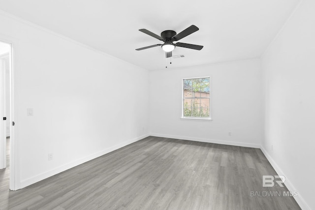 unfurnished room featuring ceiling fan, ornamental molding, and wood-type flooring