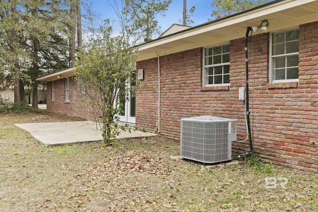 back of property with a patio area and central AC