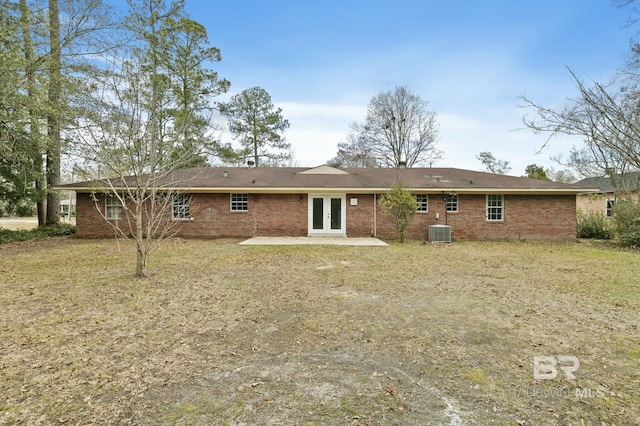 rear view of property with a patio, french doors, a yard, and cooling unit