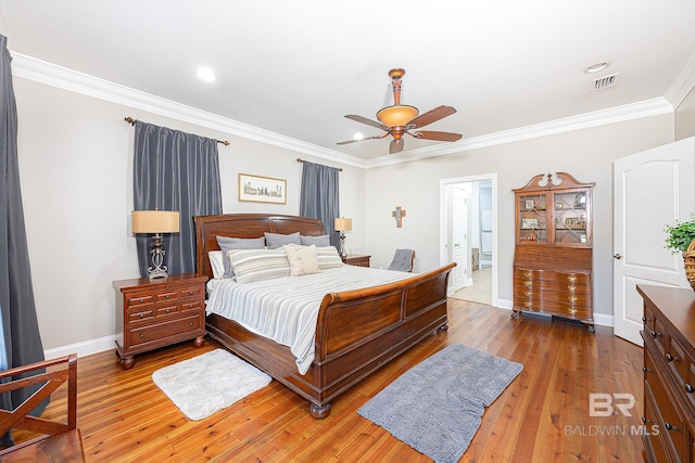 bedroom featuring crown molding, ceiling fan, and light hardwood / wood-style floors