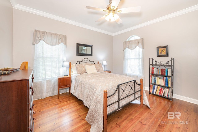 bedroom featuring crown molding, light hardwood / wood-style flooring, and ceiling fan