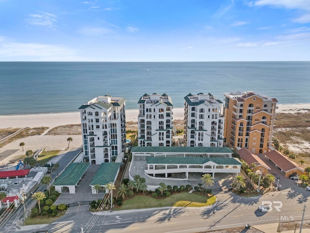 birds eye view of property with a water view and a view of the beach