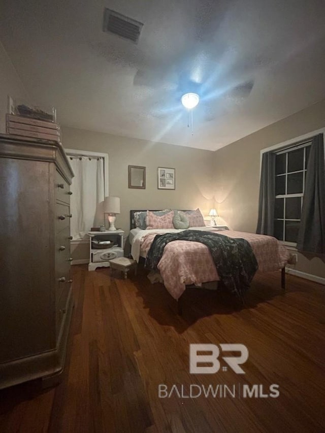 bedroom with ceiling fan and wood-type flooring