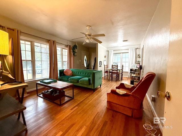 living room with hardwood / wood-style flooring and ceiling fan